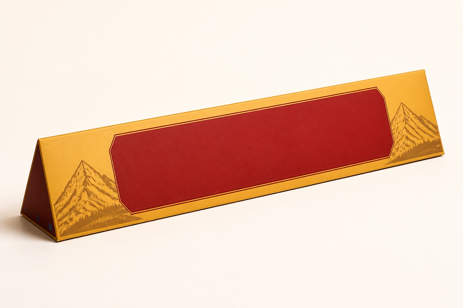 A premium triangular confectionery gift package with a blank red personalisation panel